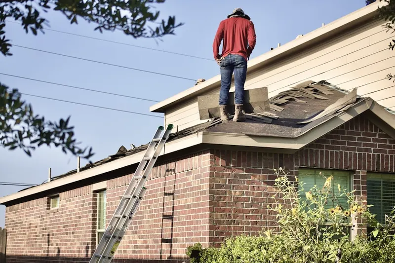 Professional roofer working on a residential roof in Ann Arbor